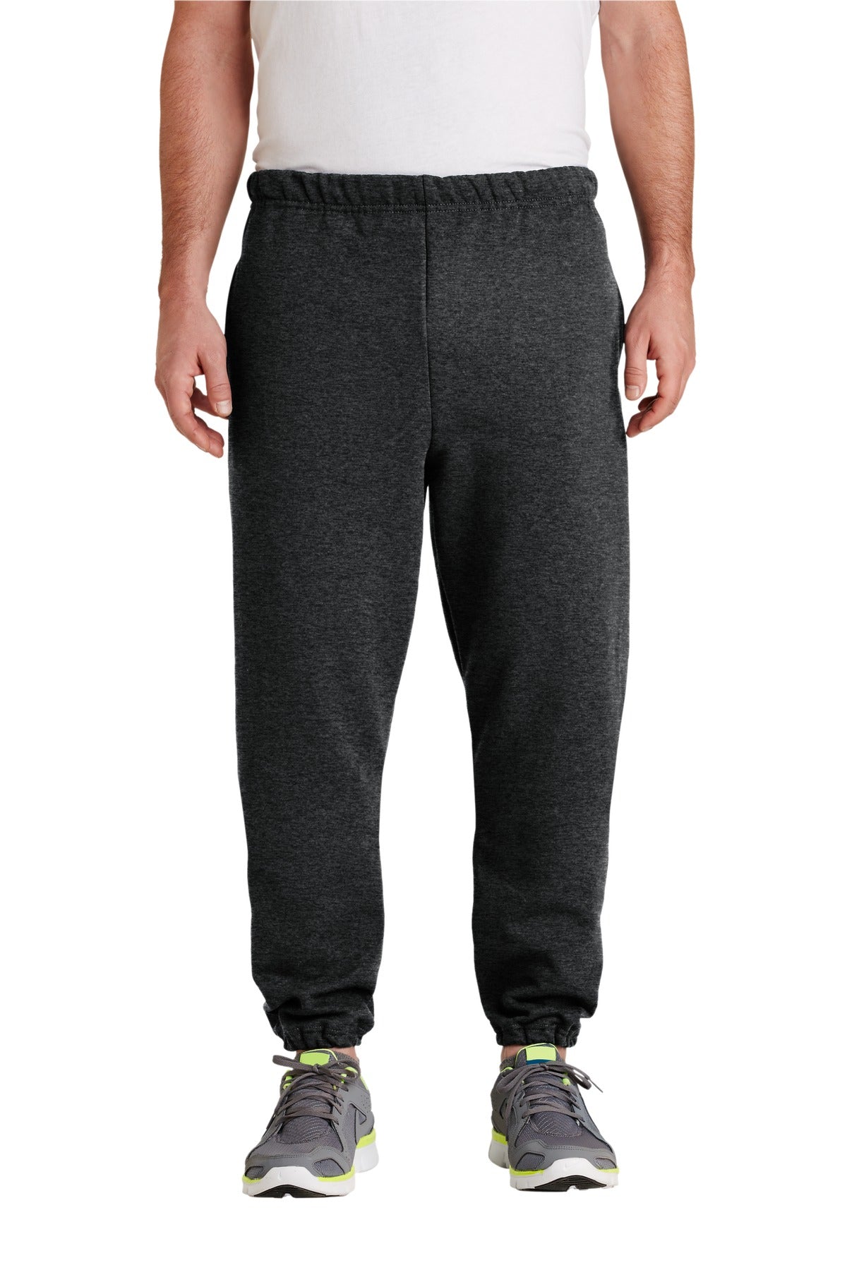 Person wearing dark gray sweatpants on a white background