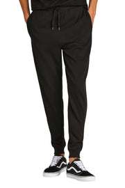 Black jogger pants worn by a person on a white background