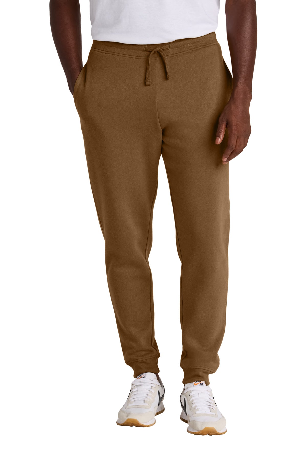Brown sweatpants worn by a person on a white background