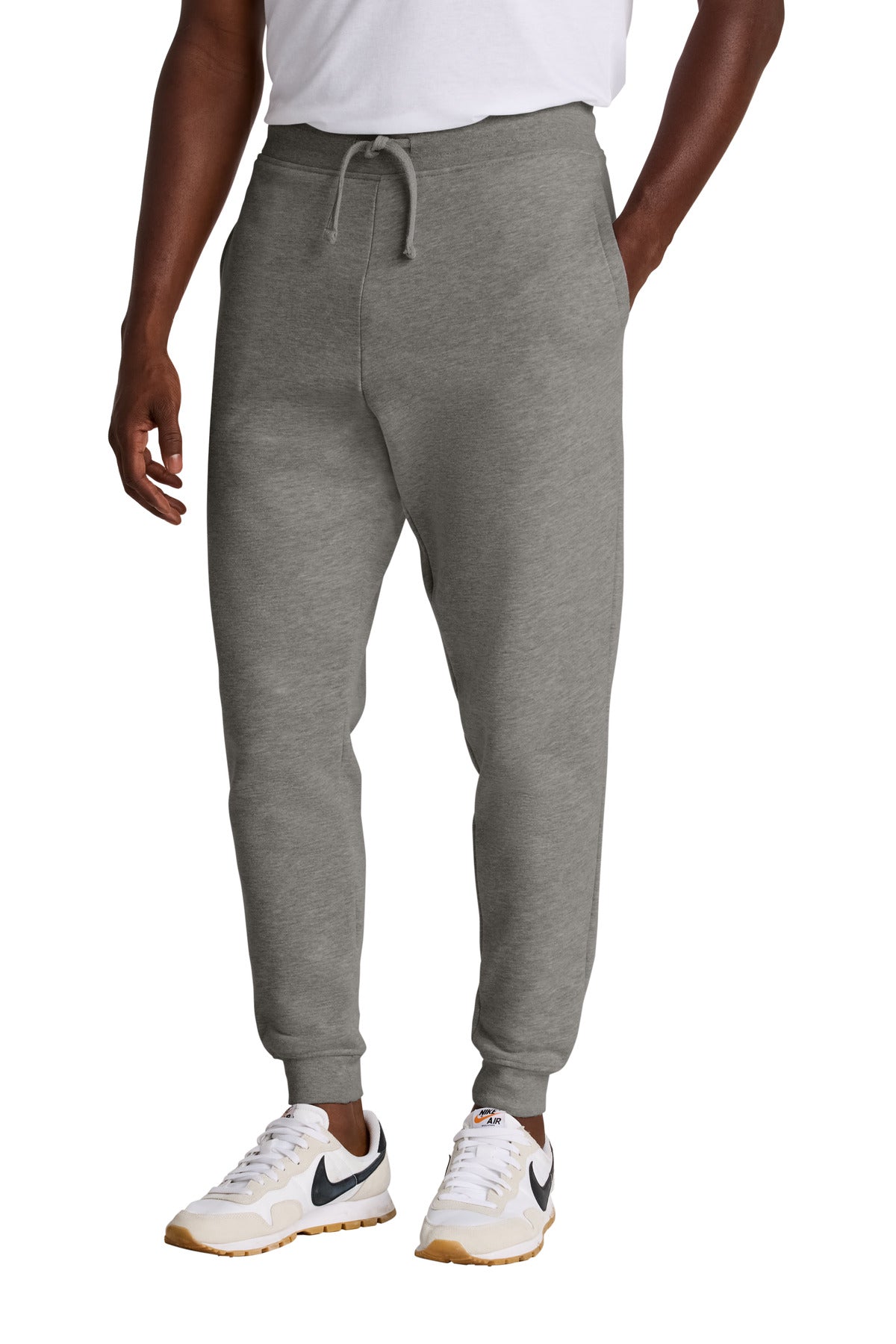Person wearing gray sweatpants with a white background