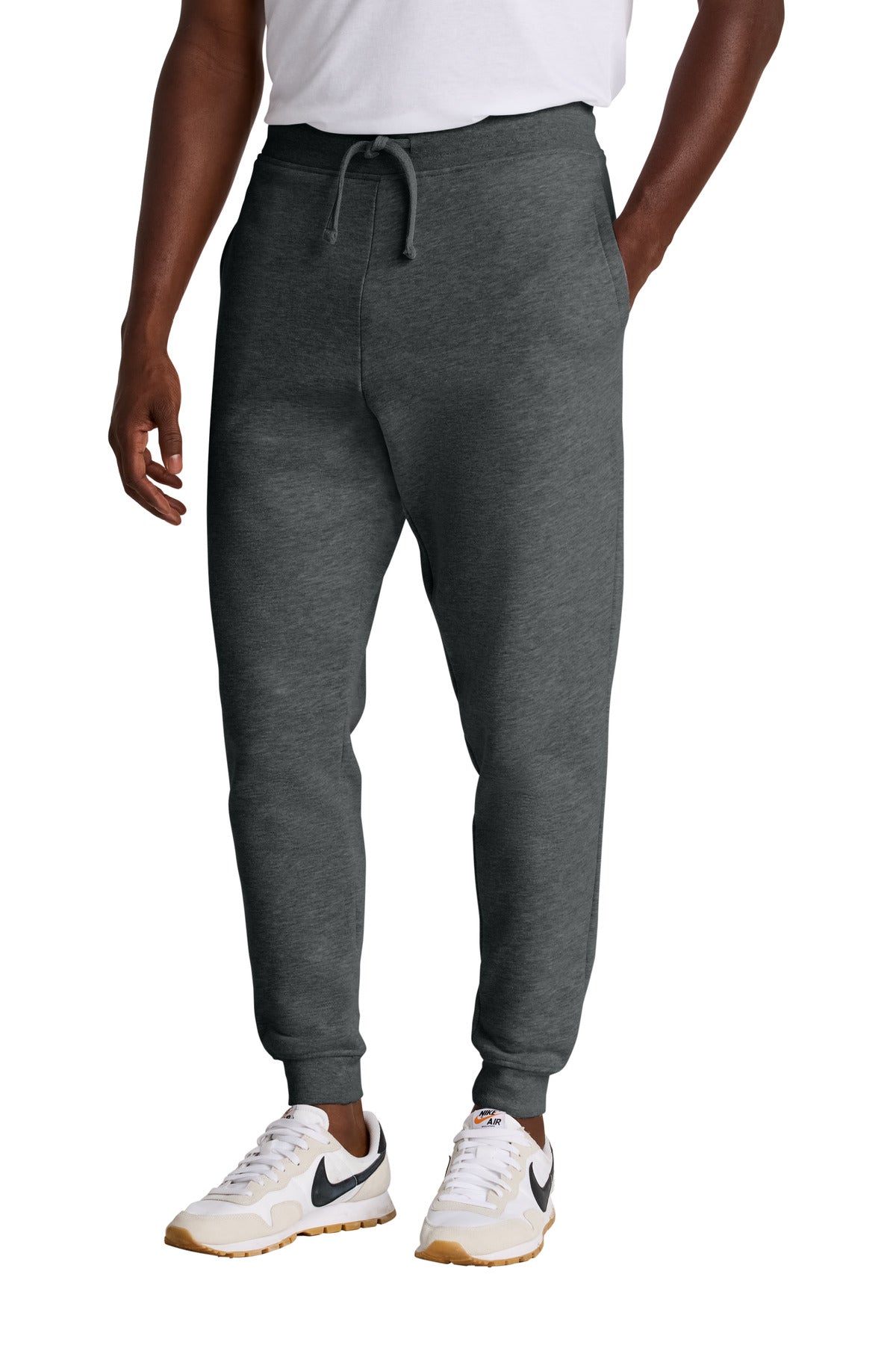 Person wearing gray sweatpants with a white background
