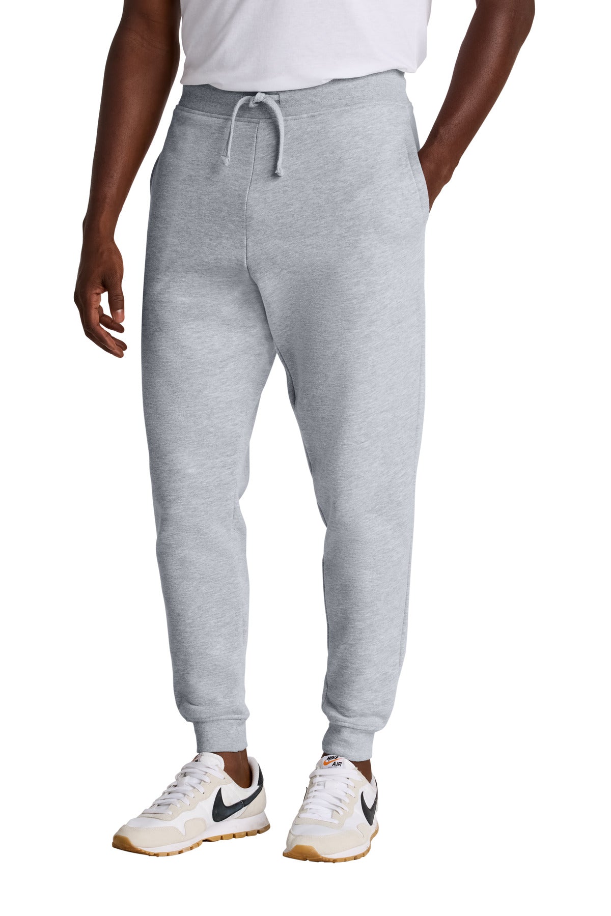 Gray sweatpants worn by a person on a white background