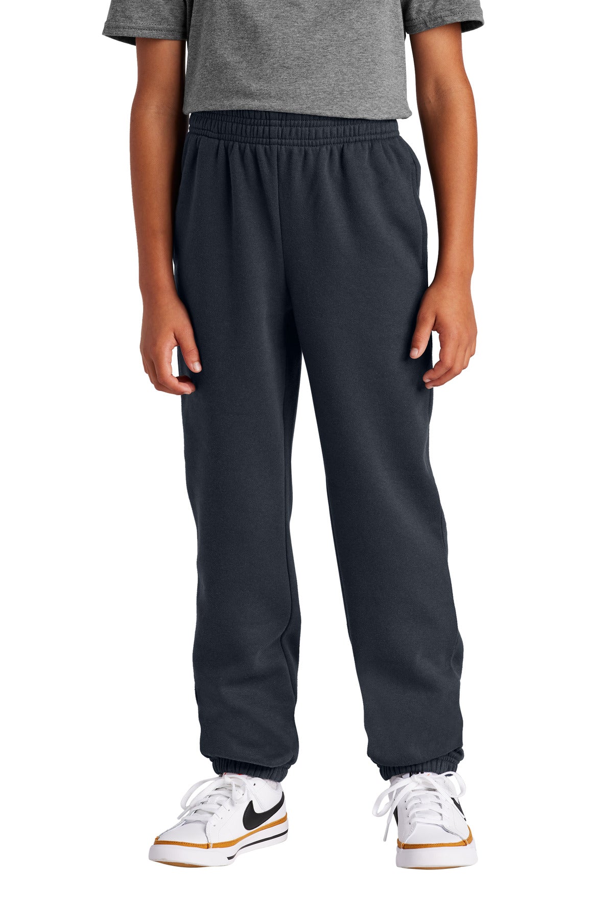 Person wearing dark gray sweatpants with a white background