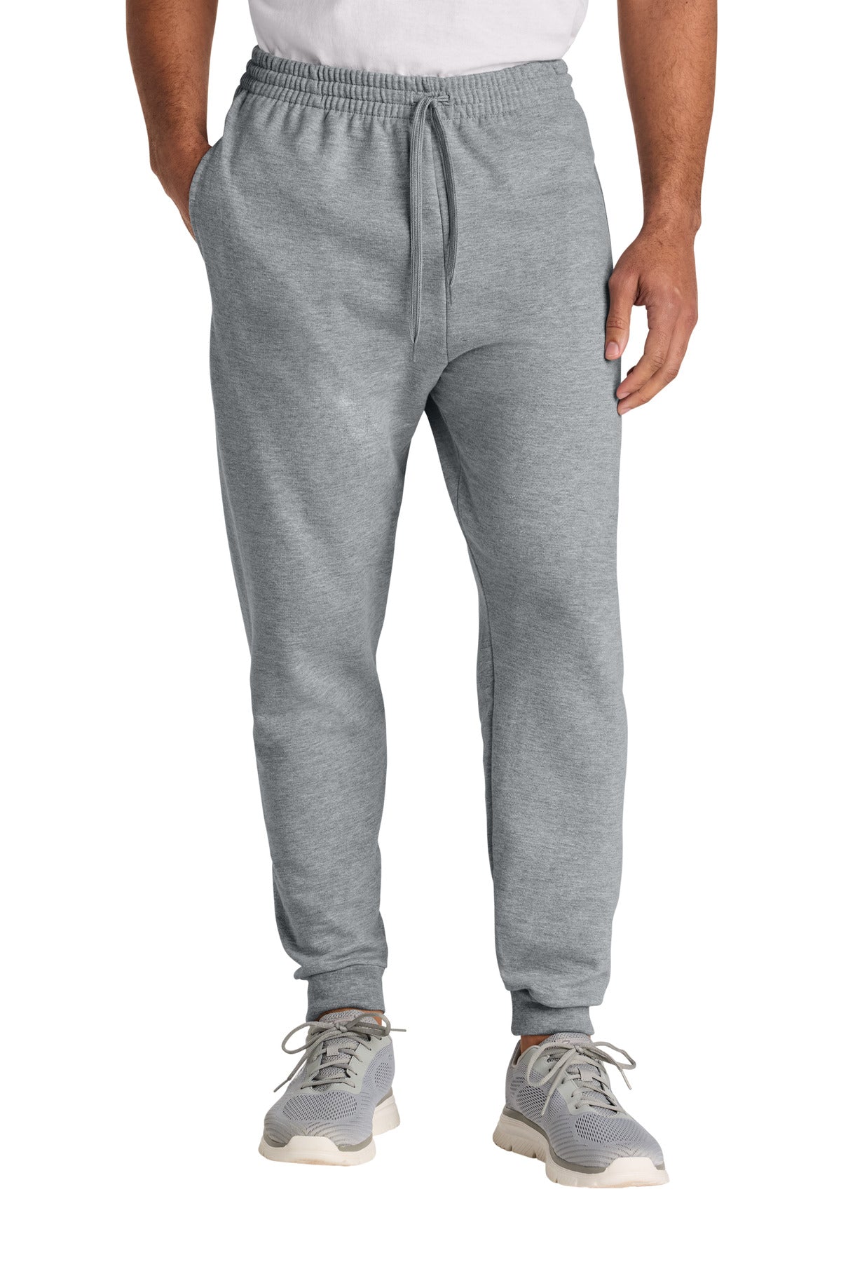 Person wearing gray jogger pants on a white background
