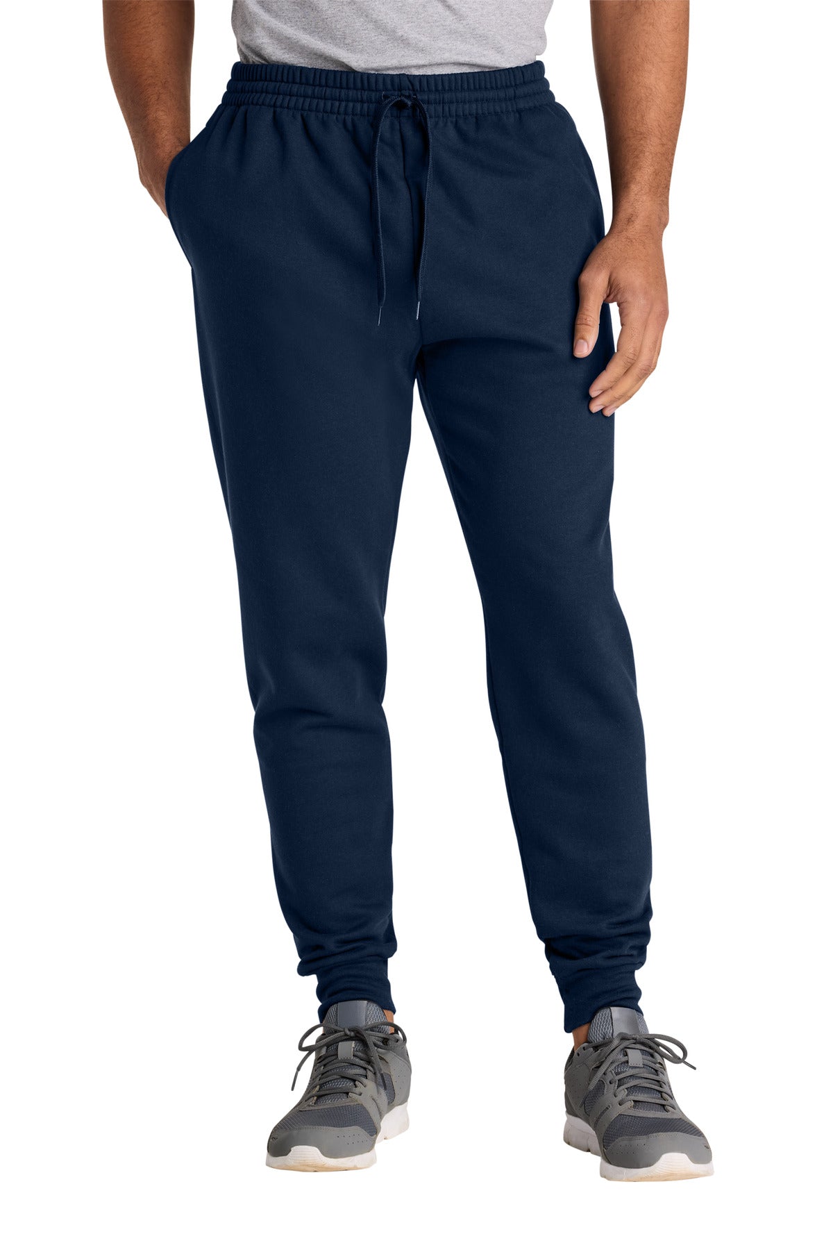 Person wearing navy jogger pants on a white background