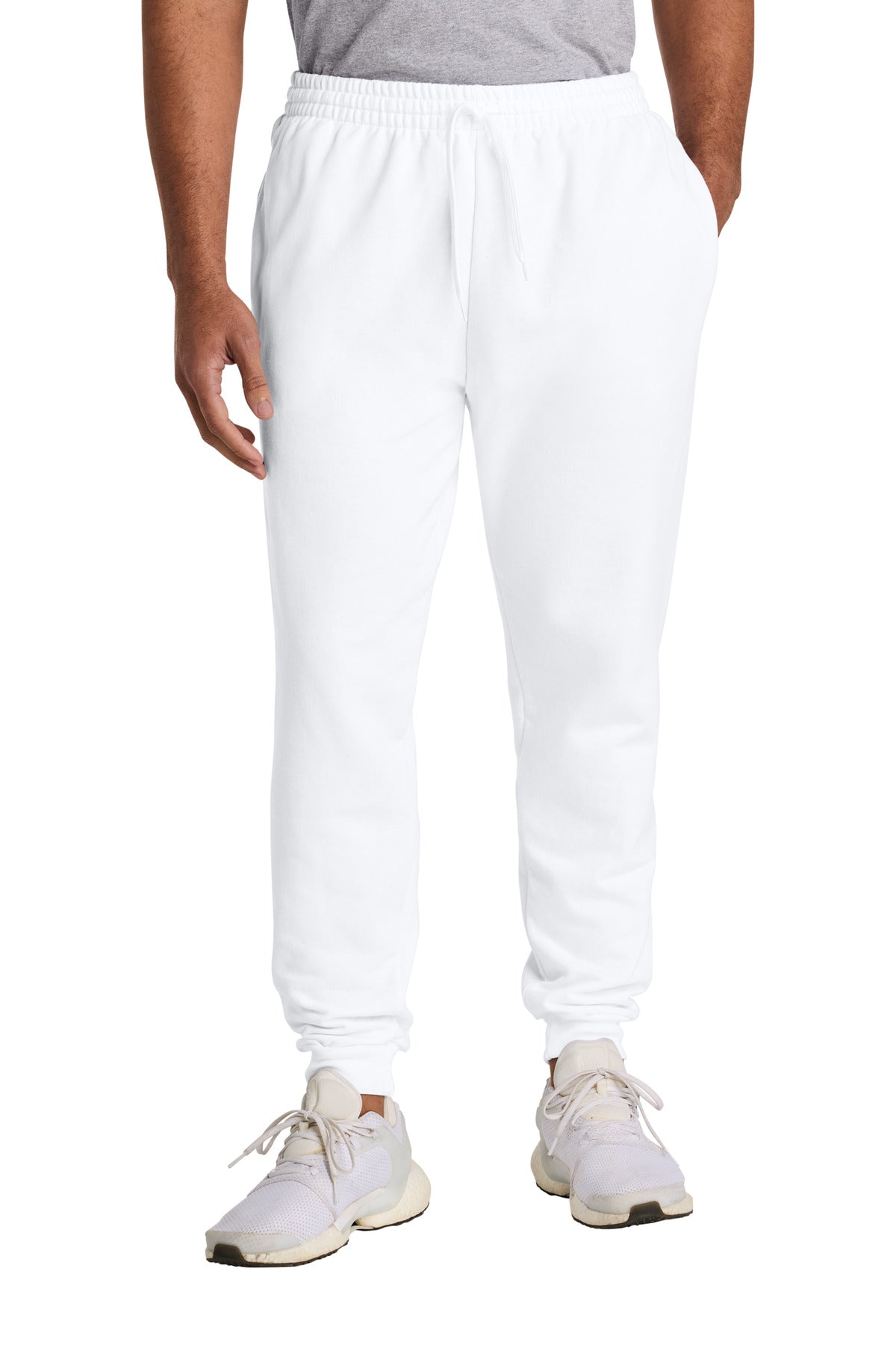 Person wearing white sweatpants and white sneakers on a white background