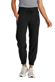 Person wearing black jogger pants on a white background