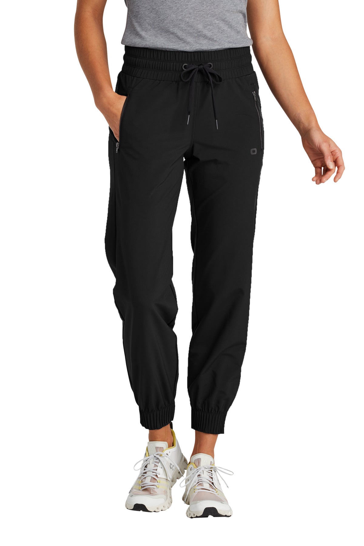 Person wearing black jogger pants on a white background