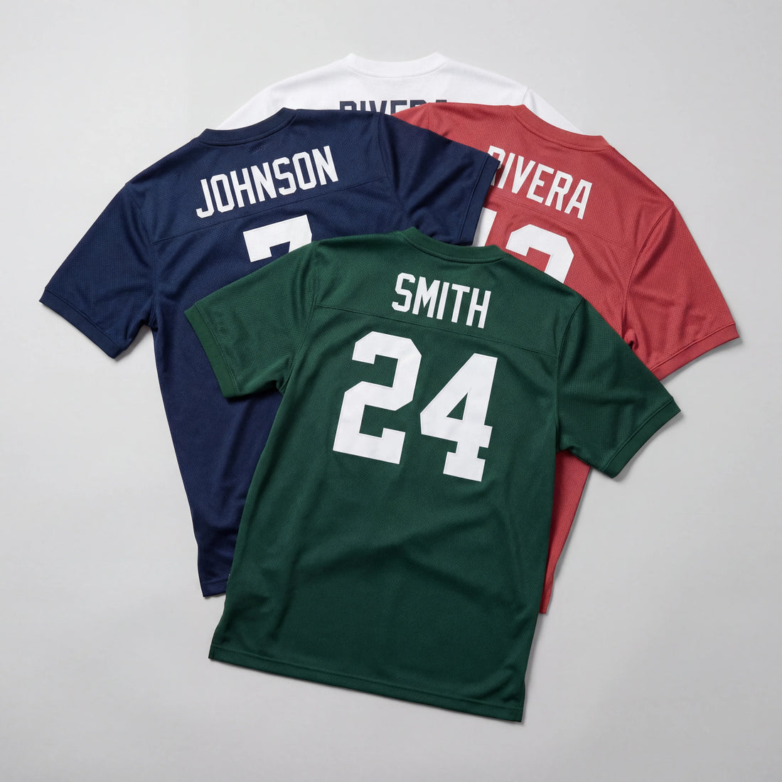 Three sports jerseys in different colors with names and numbers on a gray background