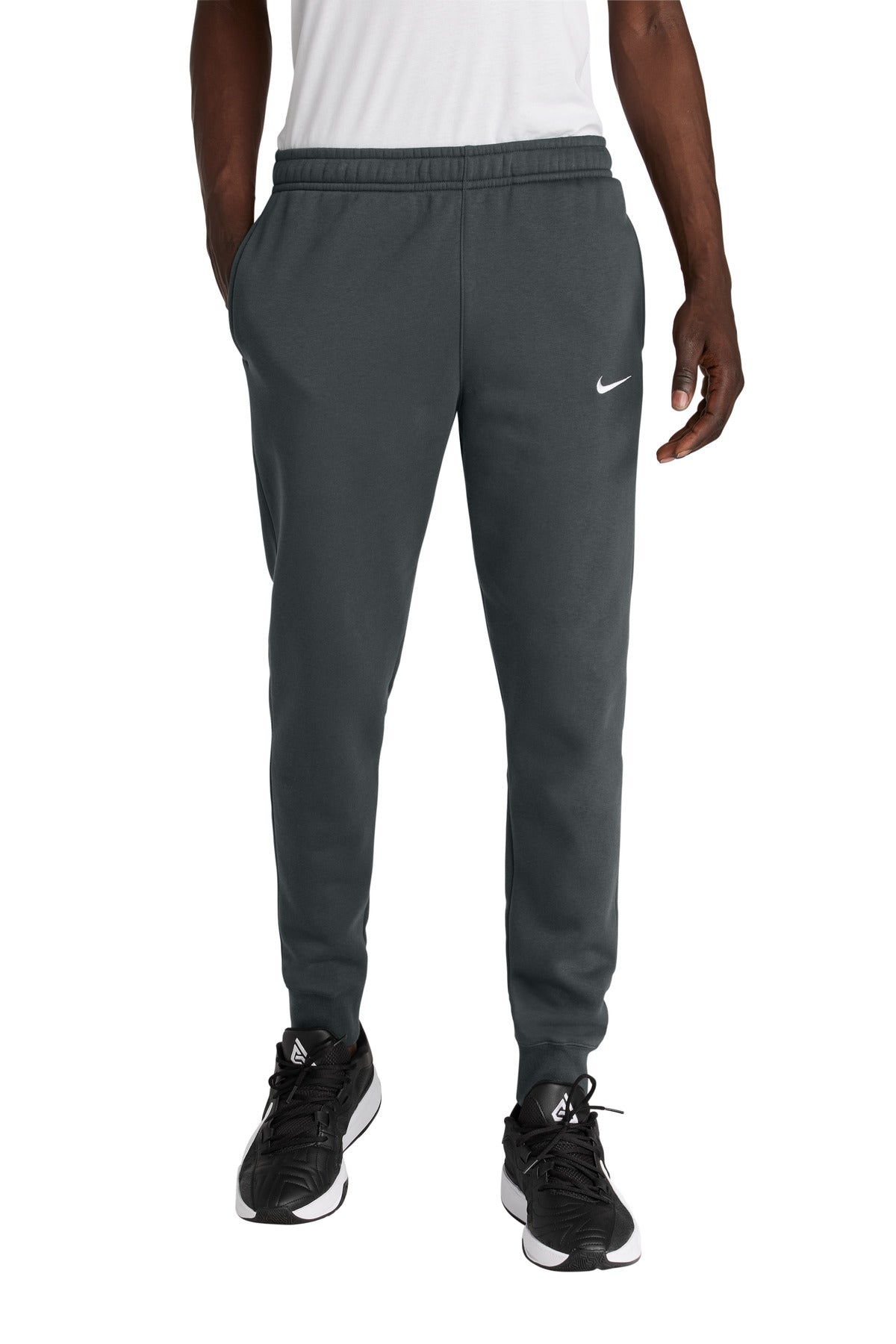 Person wearing gray Nike pants on a white background