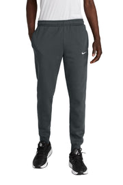 Person wearing gray Nike pants on a white background
