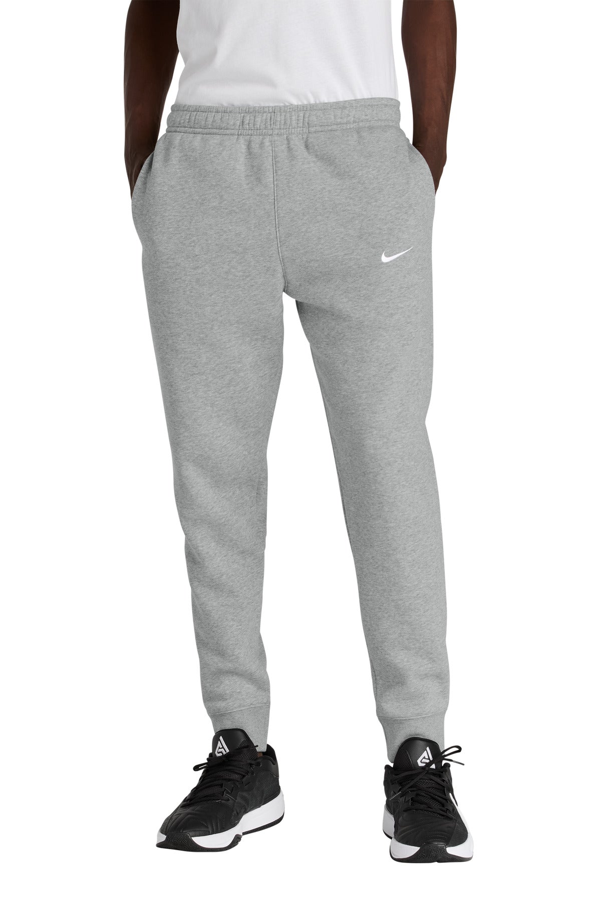 Gray Nike sweatpants worn by a person on a white background