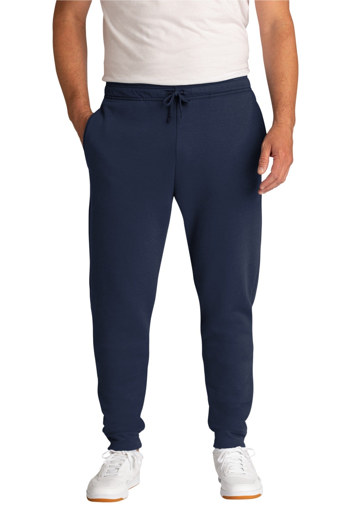 Person wearing navy blue jogger pants on a white background