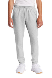 Person wearing gray sweatpants and white sneakers on a white background