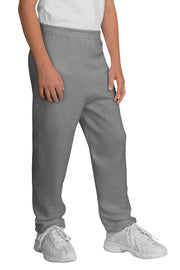 Person wearing gray sweatpants and white sneakers on a white background