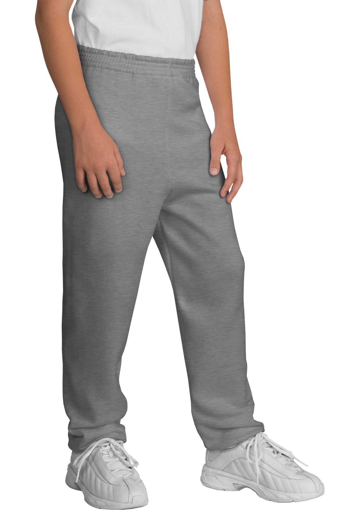 Person wearing gray sweatpants and white sneakers on a white background
