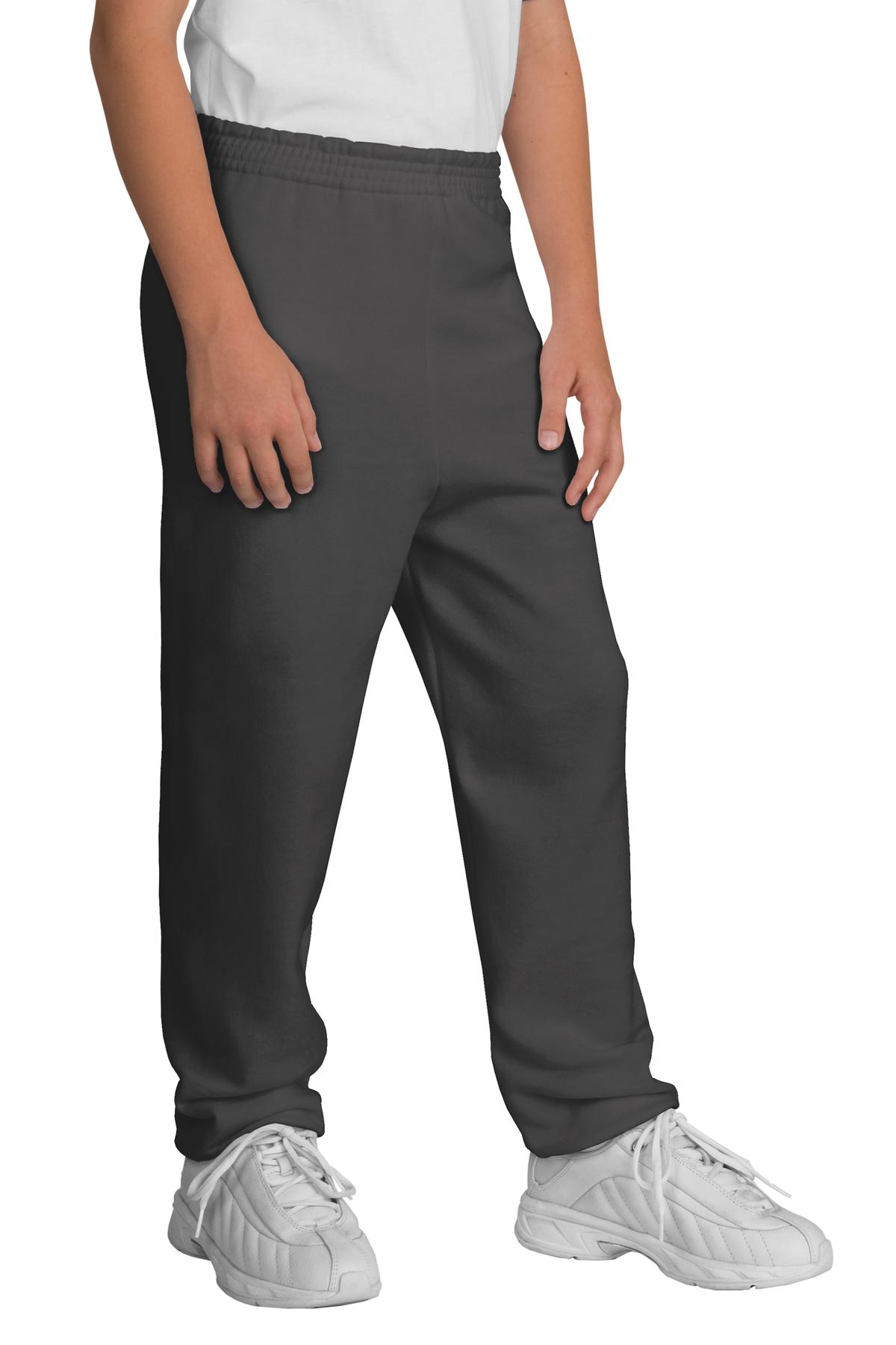 Person wearing gray sweatpants and white shoes on a white background