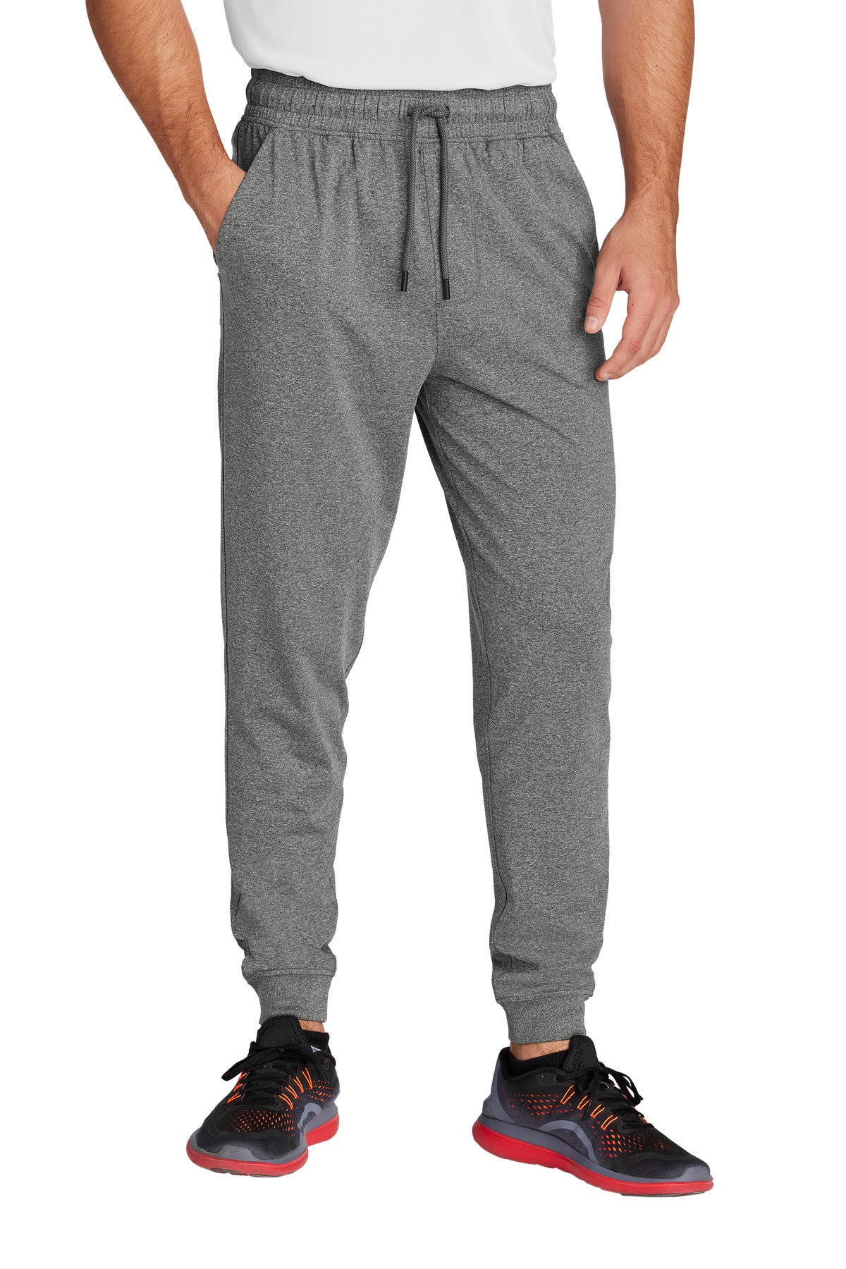 Person wearing gray jogger pants with a white shirt underneath on a white background