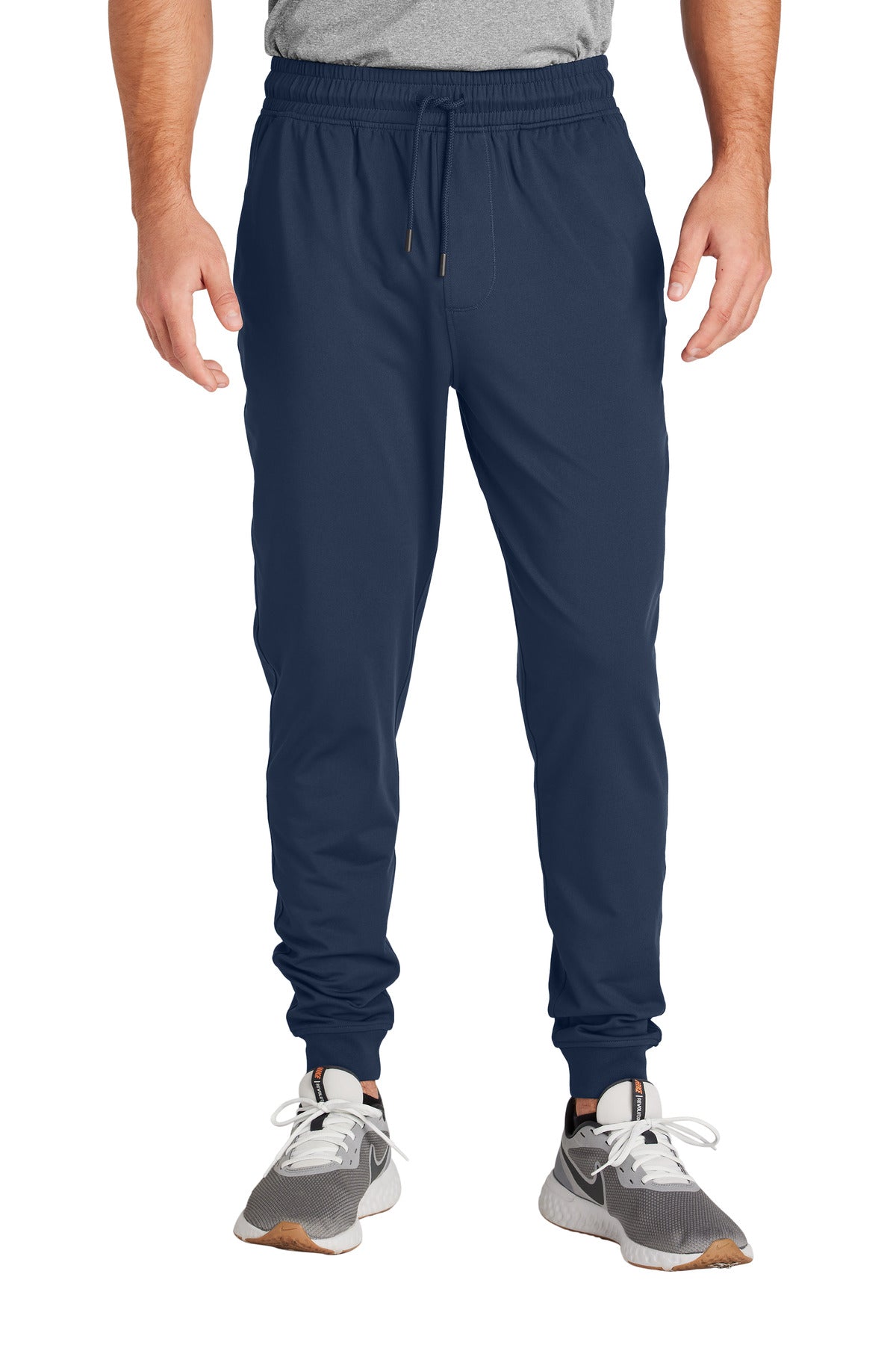 Navy jogger pants worn by a person on a white background