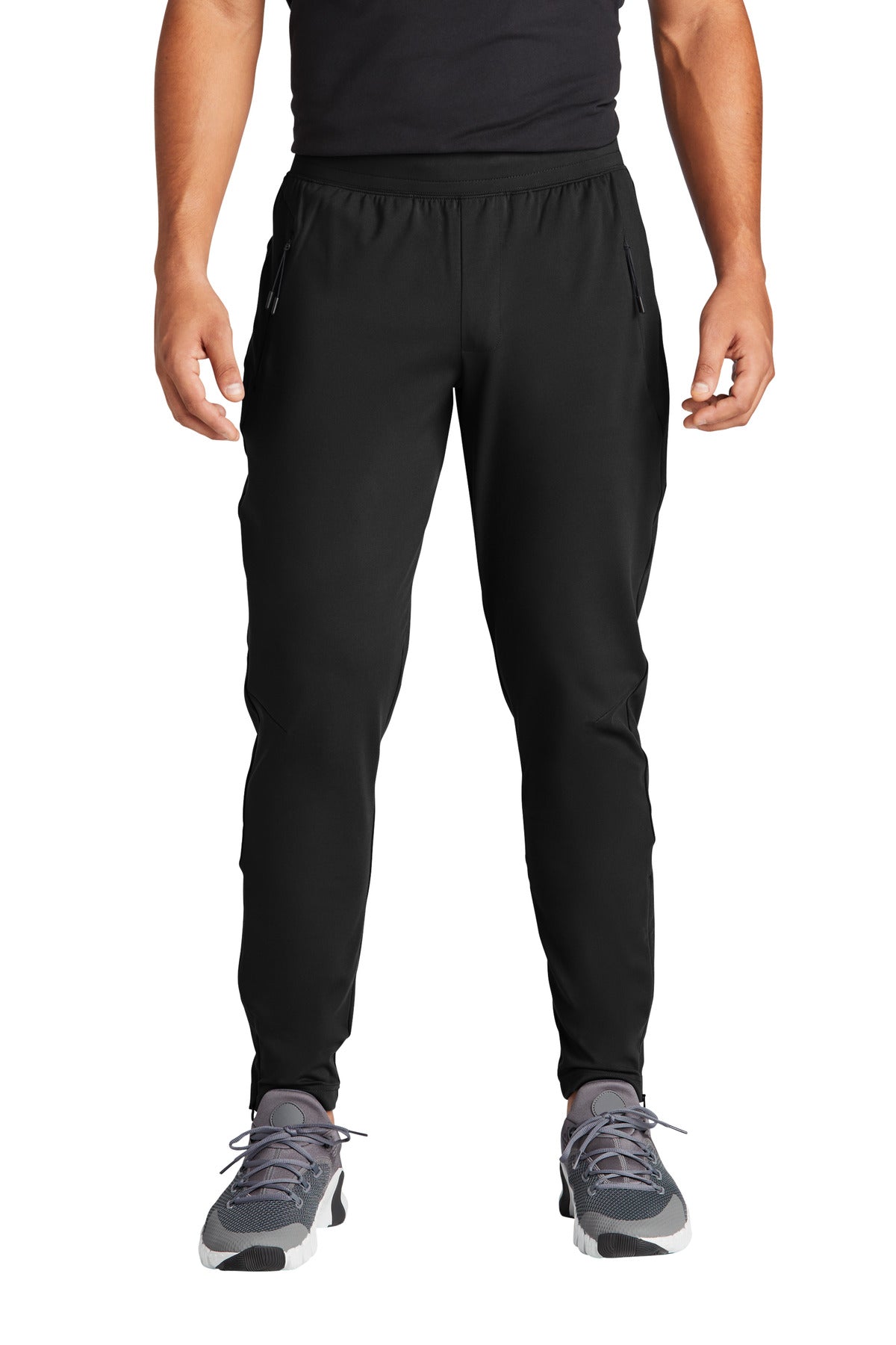 Person wearing black athletic pants on a white background