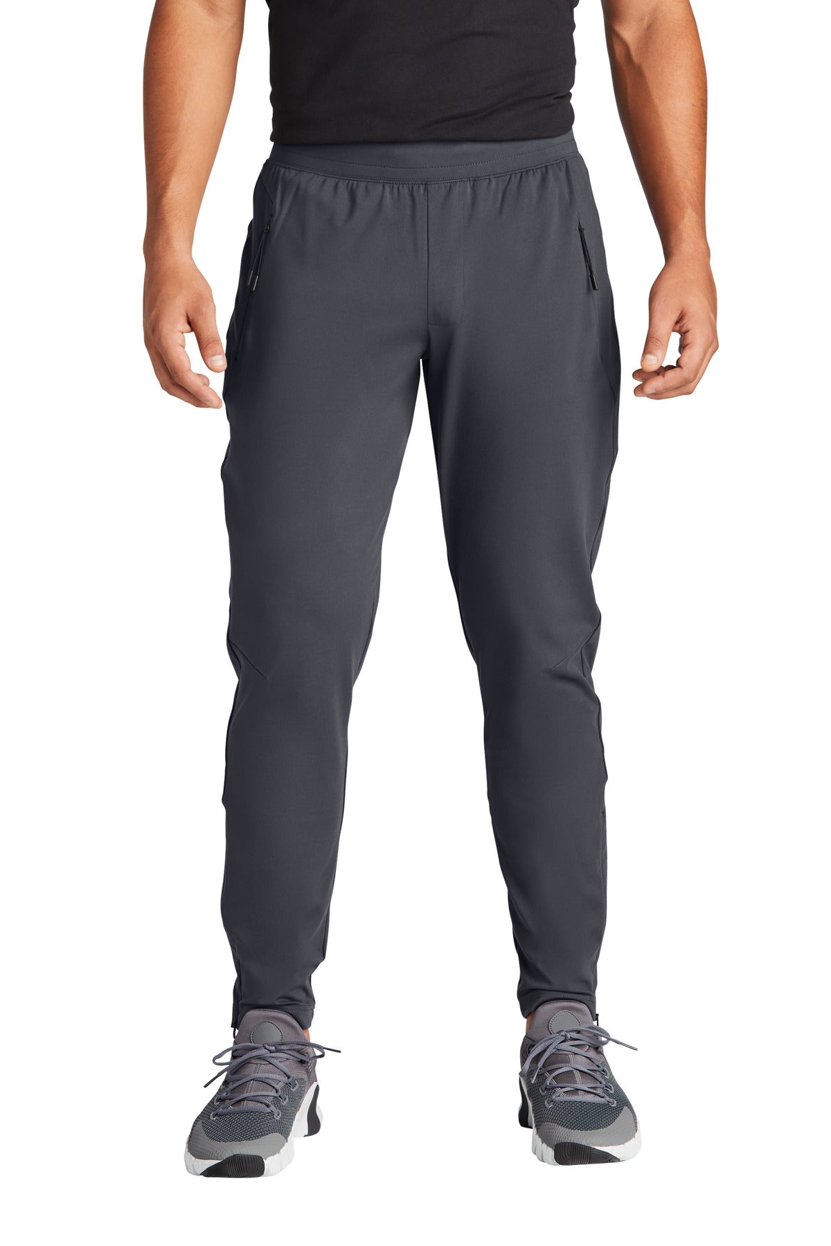 Person wearing gray athletic pants on a white background