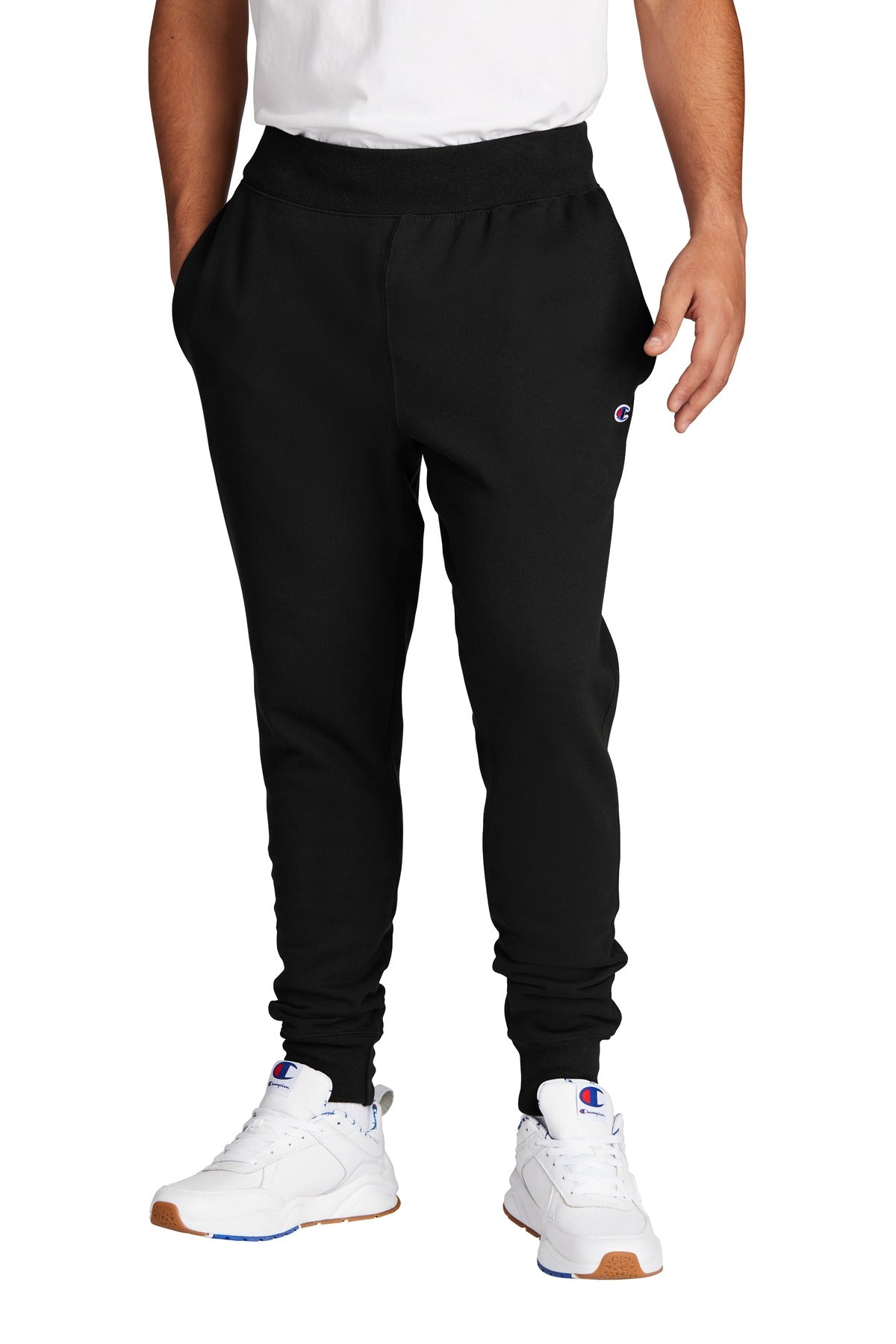 Person wearing black Champion sweatpants and white sneakers on a white background