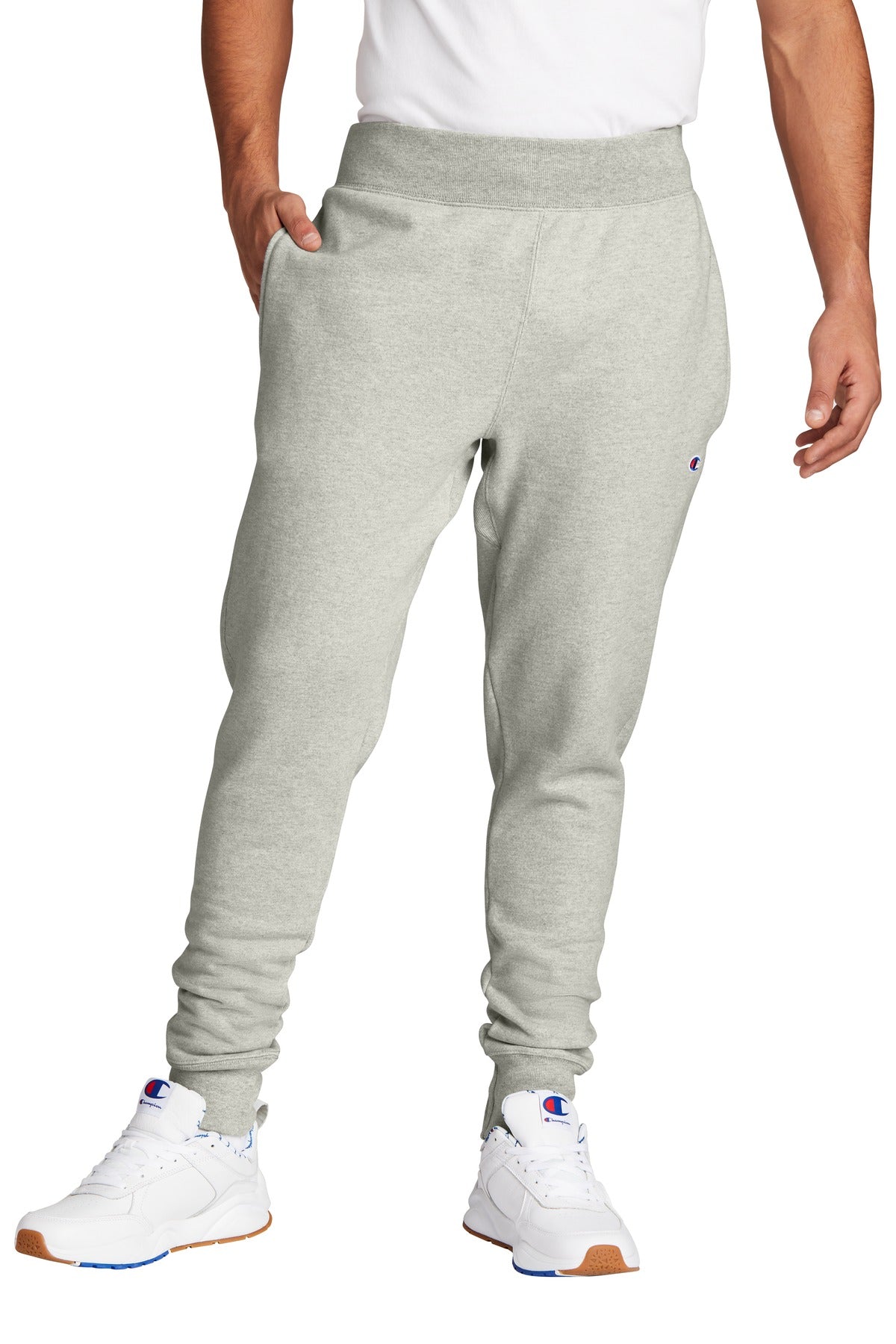 Person wearing gray sweatpants and white sneakers on a white background