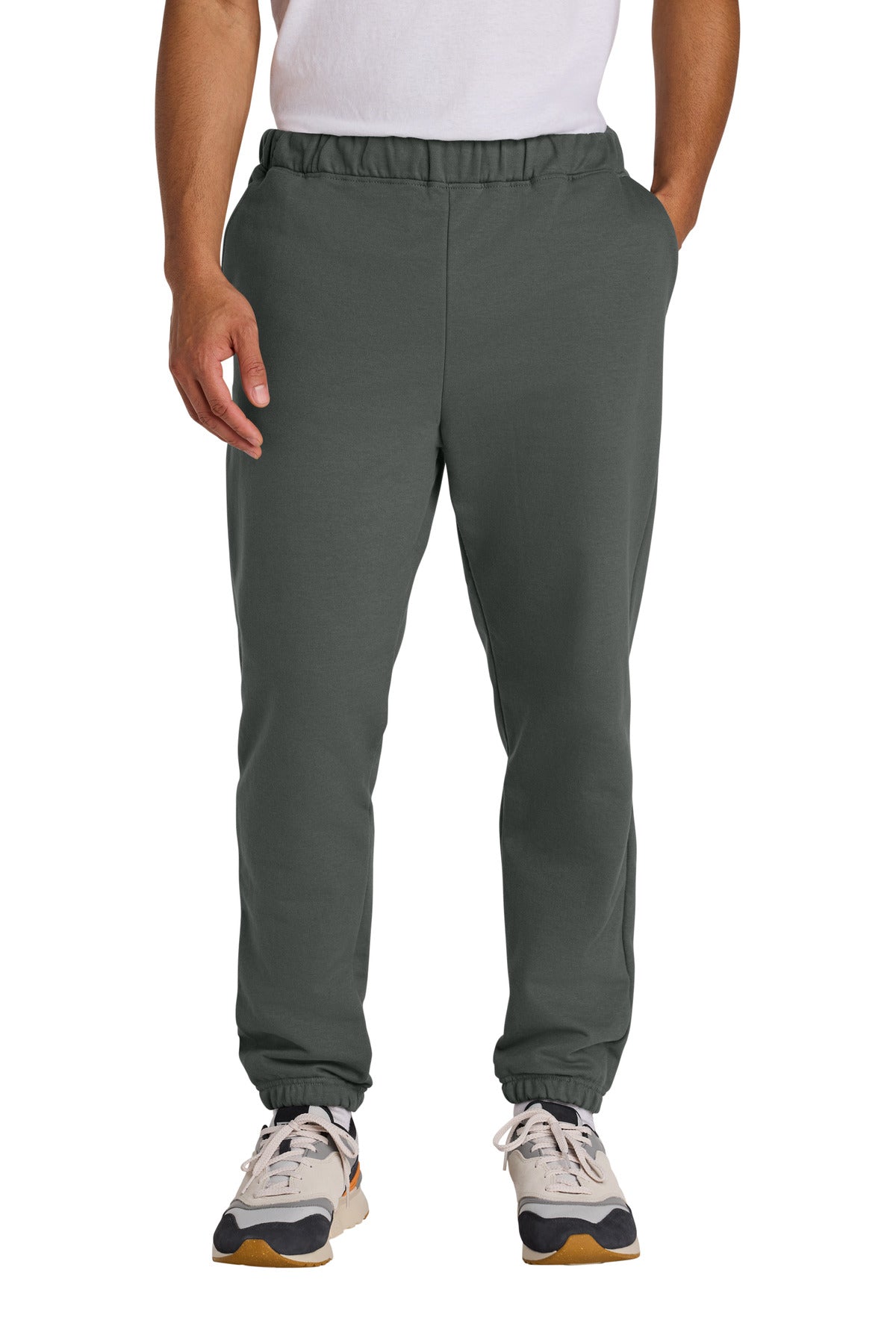 Person wearing dark gray jogger pants on a white background