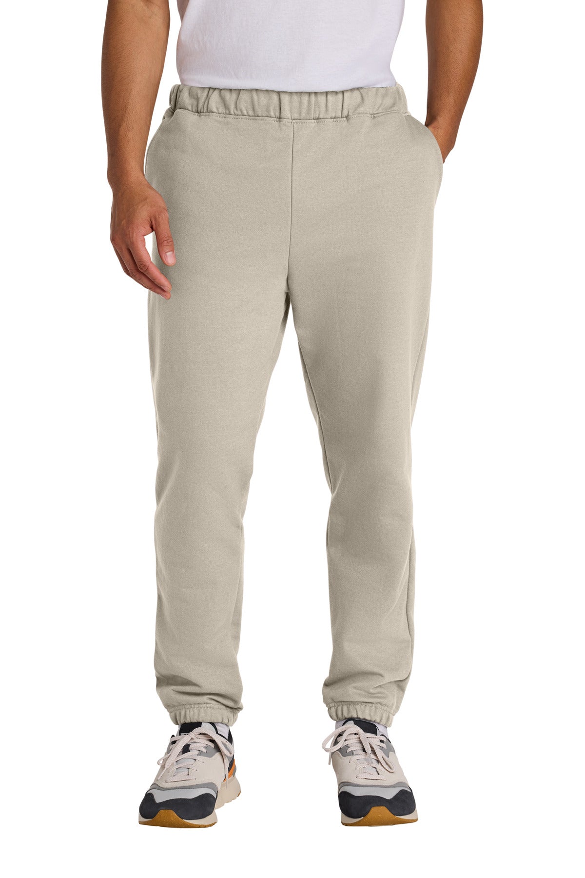 Beige sweatpants worn by a person on a white background