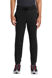 Person wearing black jogger pants on a white background