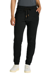 Person wearing black jogger pants with a white background