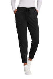 Pink jogger pants worn by a person on a white background
