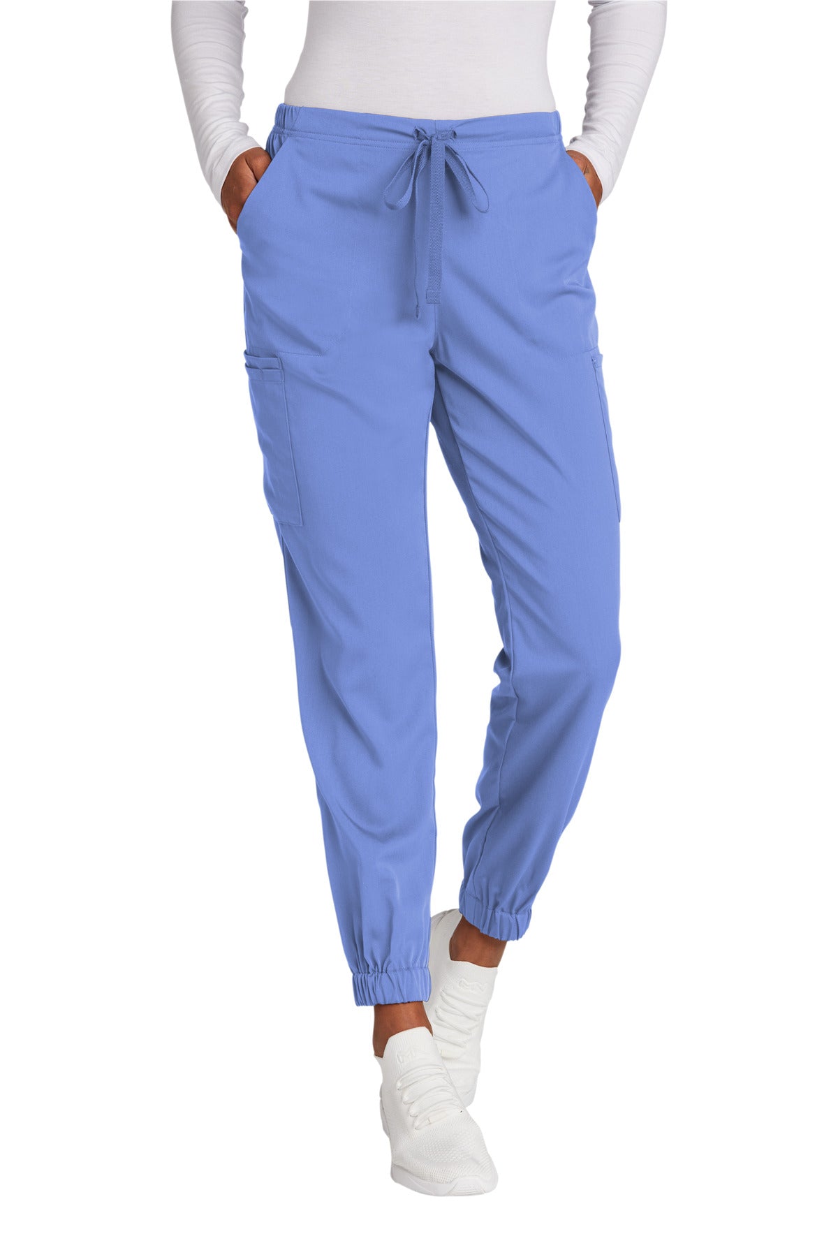 Blue scrubs pants worn by a person on a white background