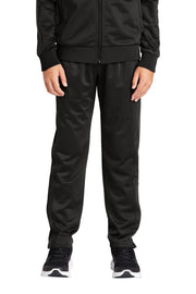 Person wearing a black tracksuit on a white background