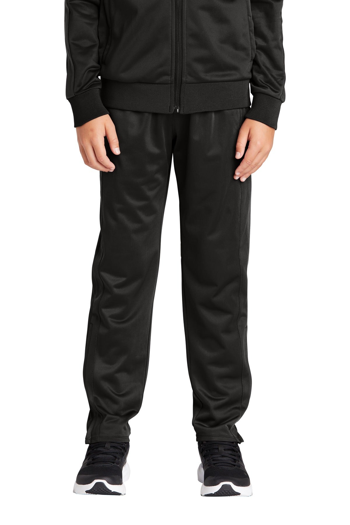 Person wearing a black tracksuit on a white background