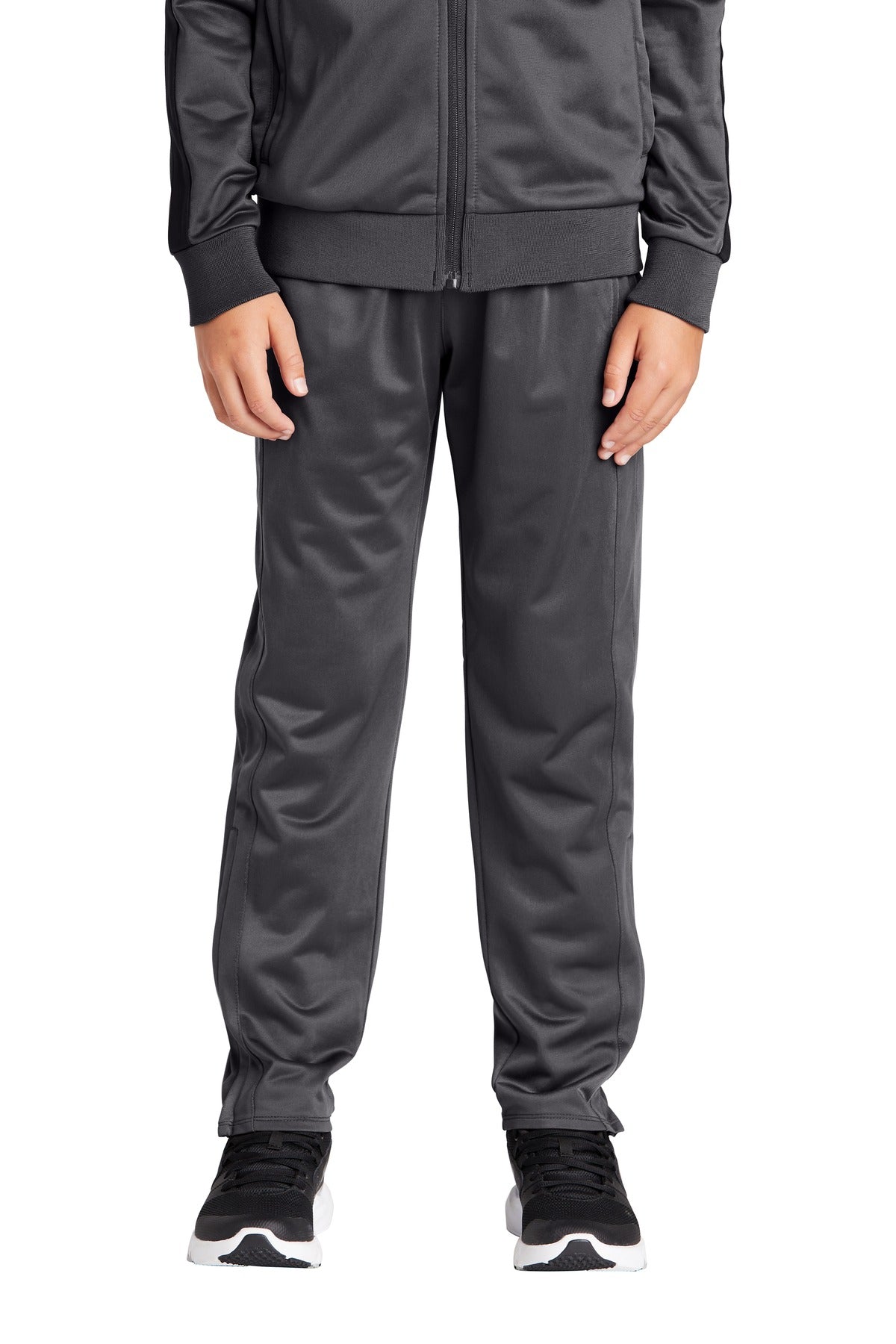 Person wearing a gray tracksuit on a white background